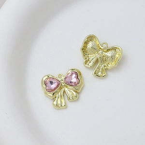 Detail showing the front and back of a pink heart crystal bow pendant for jewelry DIY