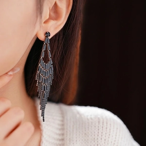Long black crystal tassel earrings with sparkling rhinestones on model profile view