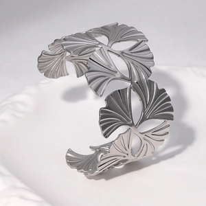 Silver ginkgo leaf open cuff bracelet in stainless steel with artistic leaf shadows