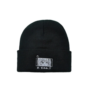 Black ribbed knit beanie with anime eye embroidery and Japanese text in white