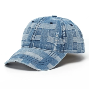 Close-up of distressed denim baseball cap detailing vintage washed fabric and stitching