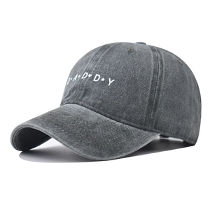 Detail of washed charcoal cotton baseball cap with white DADDY embroidery and vintage texture
