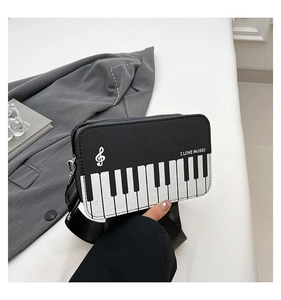 Detail of crossbody bag with piano keyboard pattern and I LOVE MUSIC text print