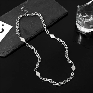 Titanium steel chain necklace with four diamond-shaped pendants on black stone surface