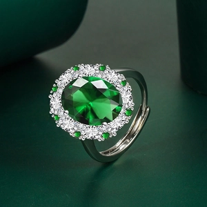 Elegant silver ring with emerald oval stone and pavé zircon halo in a luxury setting