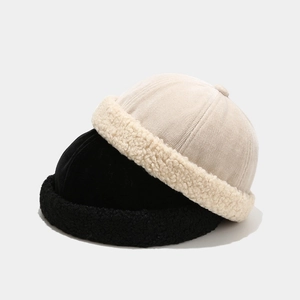 Detail of corduroy texture and thick fleece cuff on winter beanies in beige and black