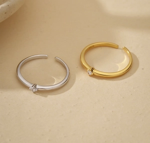 Detail of 925 sterling silver open rings with single small sparkling cubic zirconia stone