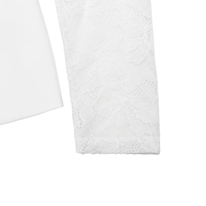 Detail of white blazer sleeve featuring lace patchwork and high-quality fabric texture