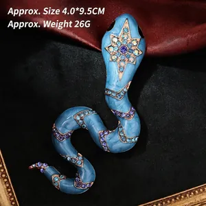 Detailed view of vintage snake brooch with blue enamel, rhinestones and size measurements