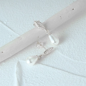 Detail showing S925 sterling silver stamp and elegant drop-shaped pearl on retro earrings