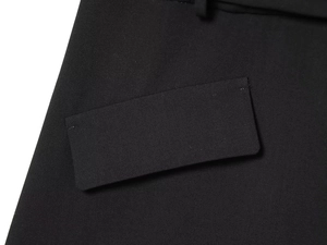 Detail of premium black woven fabric and expert stitching on the suit jacket pocket flap