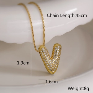 Detail shot of gold letter V pendant with cubic zirconia and dimension labels