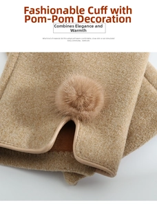Detailed close-up of the elegant camel wool gloves featuring a soft fur ball and leather trim