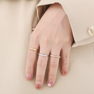 Octagon stainless steel rings in gold silver and rose gold finishes on model's hand