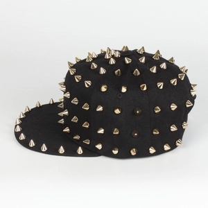 Close-up of a black snapback cap featuring punk style golden metal cone studs and flat brim