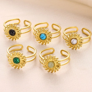 Detailed set of five vintage gold rings with colorful stone centers and twist bands