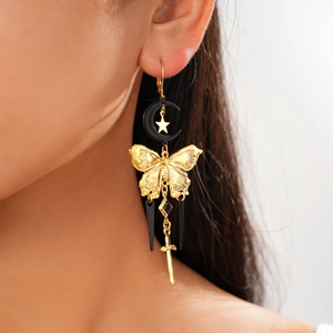 Detail of gold butterfly and sword tassel earrings with moon and star pendants