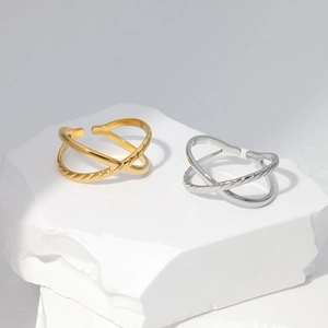 Macro shot of minimalist adjustable criss-cross rings in gold and silver finish