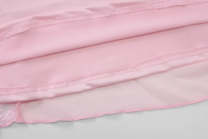 Macro detail of pink satin fabric with neat double stitching and delicate lace trim
