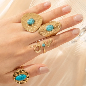 Luxury gold adjustable snake heart rings with tiger eye stone on silk background