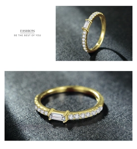 Detailed views of gold ring with emerald-cut gemstone and round side diamonds