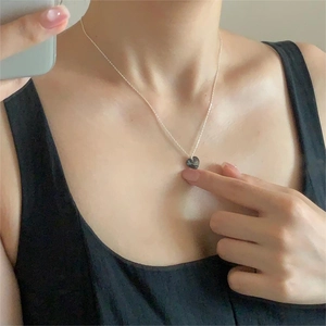 925 Sterling Silver necklace with a faceted black heart crystal pendant worn on neck