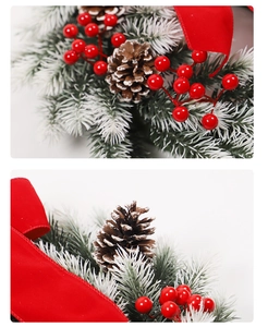 Close-up of frosted pine needles, red berries and velvet bow on Christmas wreath