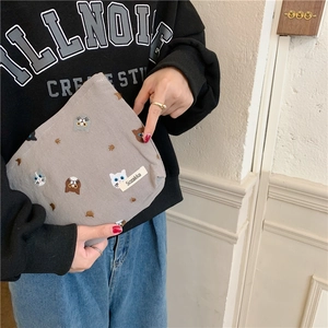 Japanese style grey canvas makeup bag with cute cat embroidery held by a model