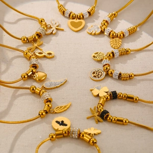 Gold-plated snake chain bracelet set featuring tree of life and heart crystal charms