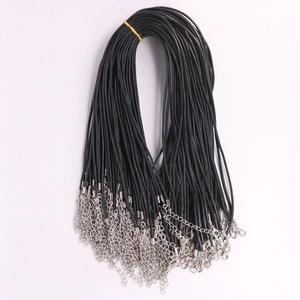 Detailed view of black necklace cords with lobster clasps and extension chains on white