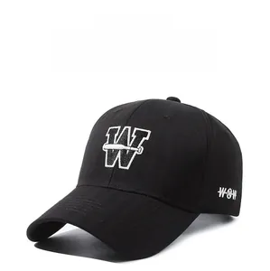 Detail shot of white embroidered W letter on a premium black cotton baseball cap