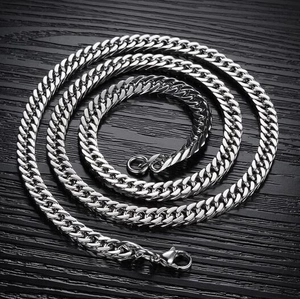 Polished silver stainless steel Cuban link chain necklace with lobster clasp on dark wood