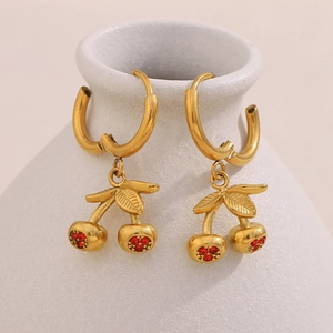 Detail of 18K gold-plated cherry earrings with sparkling red rhinestones on ceramic base