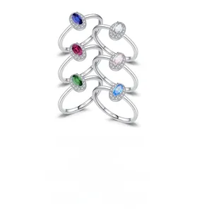 Macro detail of six colorful halo oval gemstone rings in S925 sterling silver