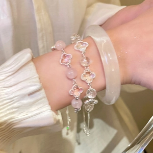 Detail of beaded clover bracelets with pink and clear crystals on a wrist
