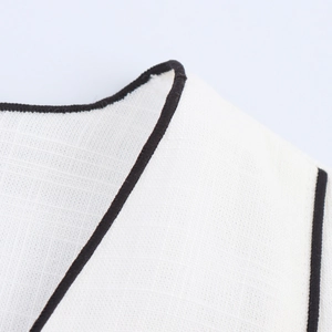 Summer V-neck set featuring white textured fabric with black contrast piping detail