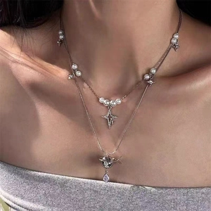 Double-layer silver necklace with pearls, star charms, and a purple teardrop crystal stone