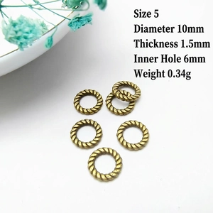 Detail view of 10mm antique bronze textured ring spacers with size specifications