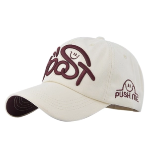 Macro detail of high-quality BOOST embroidery on beige cotton baseball cap with curved brim
