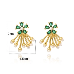 Detail of flower tassel earrings with green crystals, pearls and gold drop pendants