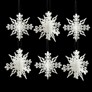 Set of six white 3D stereo plastic snowflakes hanging on a Christmas tree display
