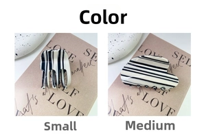 Detail view of small and medium zebra striped hair claws with a premium glossy finish