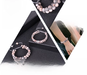 Detail of double-layer pink zebra stone beaded bracelet with adjustable woven cord