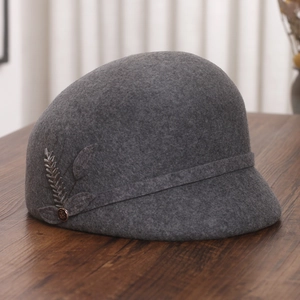 Detail of dark grey wool cloche hat featuring elegant wheat sequin embroidery and beadwork