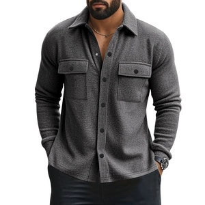 Close-up of charcoal grey men's jacket showing textured fabric and chest pocket detail