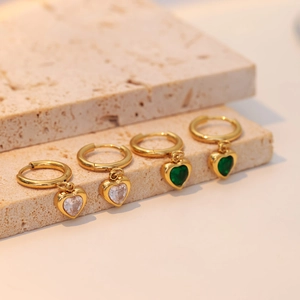 Elegant heart emerald necklace and earring set in gold on minimalist stone display