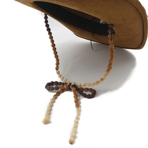 Detail of western suede hat featuring bohemian beaded chin strap and inner sweatband