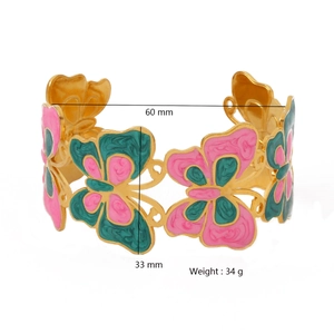 Wide gold butterfly bangle with pink and green enamel details, 33mm width, open cuff design
