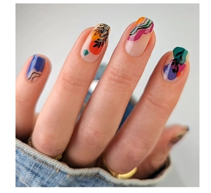 Macro view of glossy multicolor abstract nail art with vibrant leaf and wave patterns