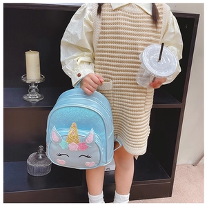 Close-up detail of blue unicorn backpack with shiny sequins and cute 3D horn for girls